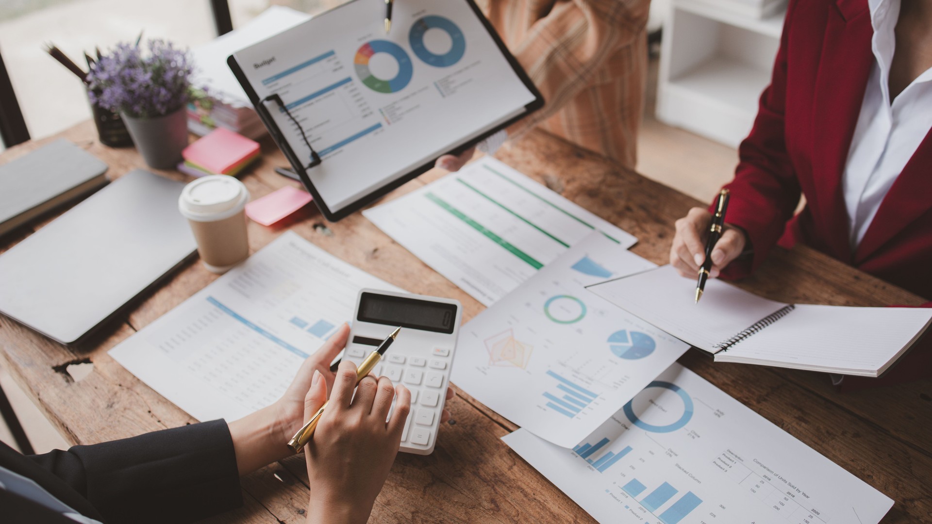 Businessman is reviewing monthly sales documents for analysis and marketing plans for more sales growth, they are the founders of young companies co-founding startups. Sales management concept.